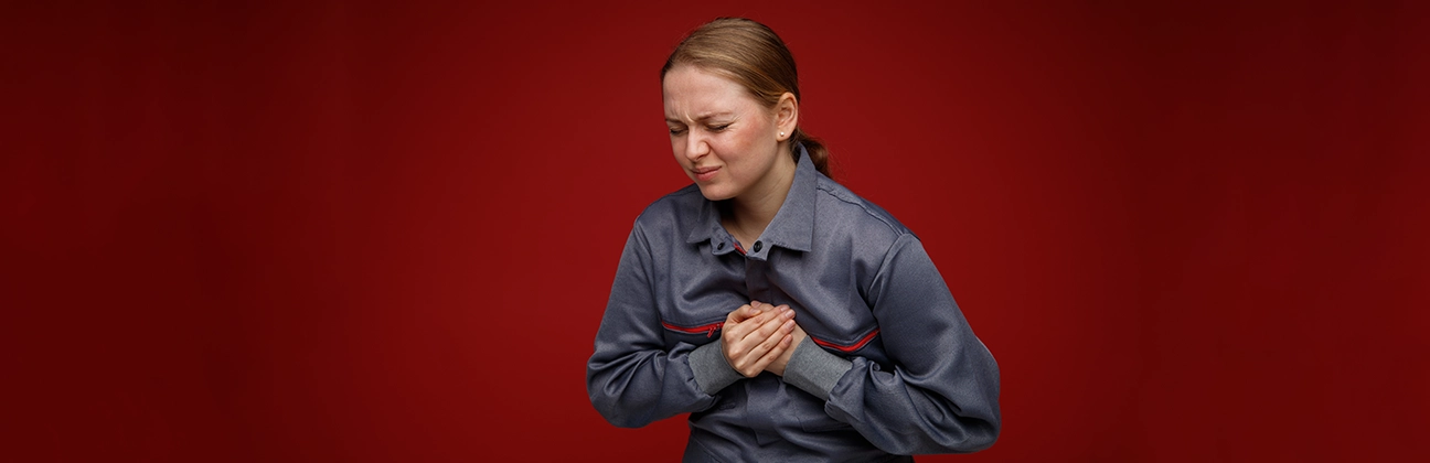 Person experiencing heartburn discomfort with a burning sensation in the chest and upper stomach area.