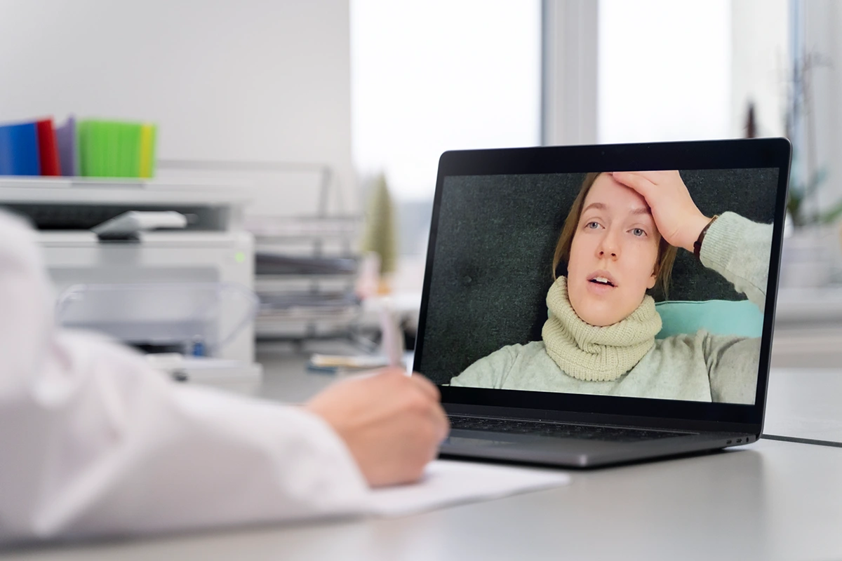 Patient speaking with a mental health professional through a secure telehealth video consultation
